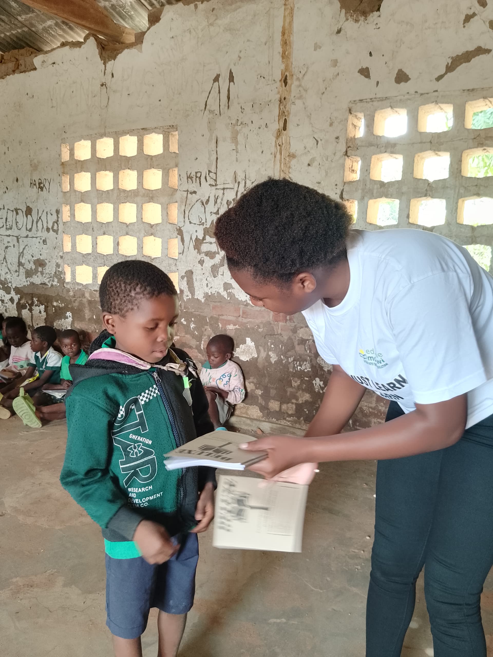 Staff member helping child with educational materials