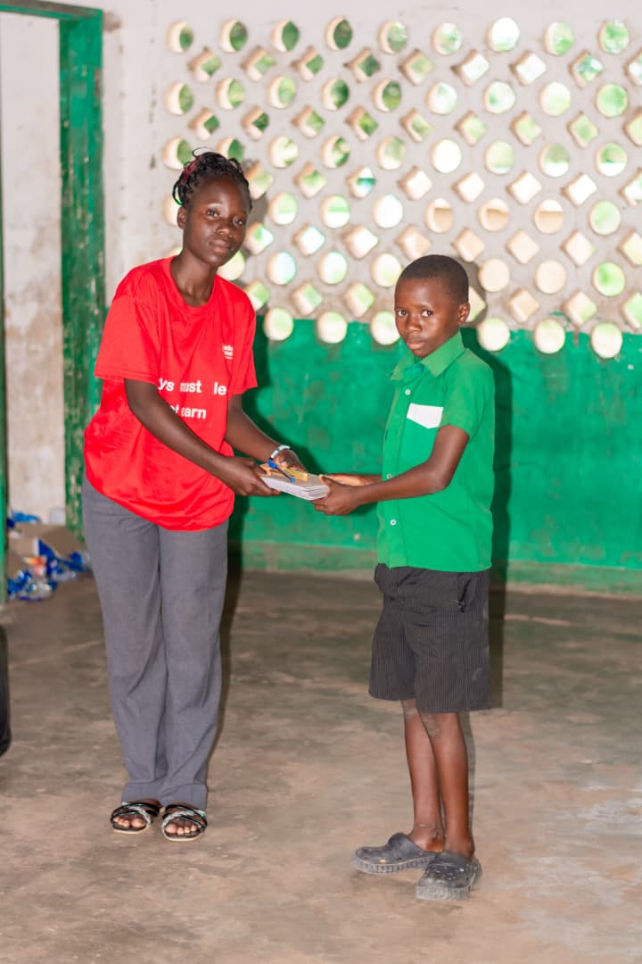 Student receiving materials from volunteer